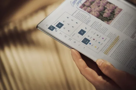 A reMarkable paper tablet displaying writing tools held in hand.