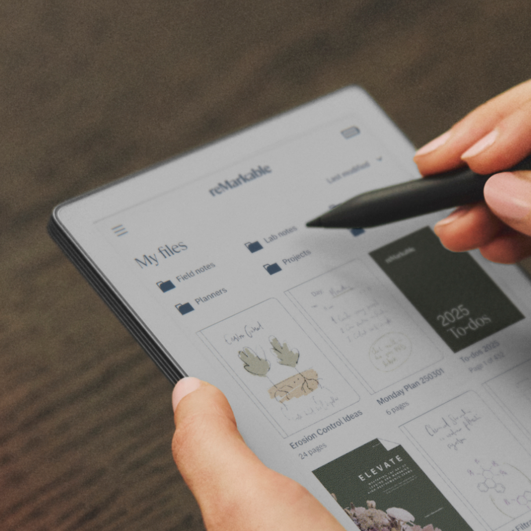 A reMarkable Paper Pro Move displaying an organized home screen, with folders and tags.
