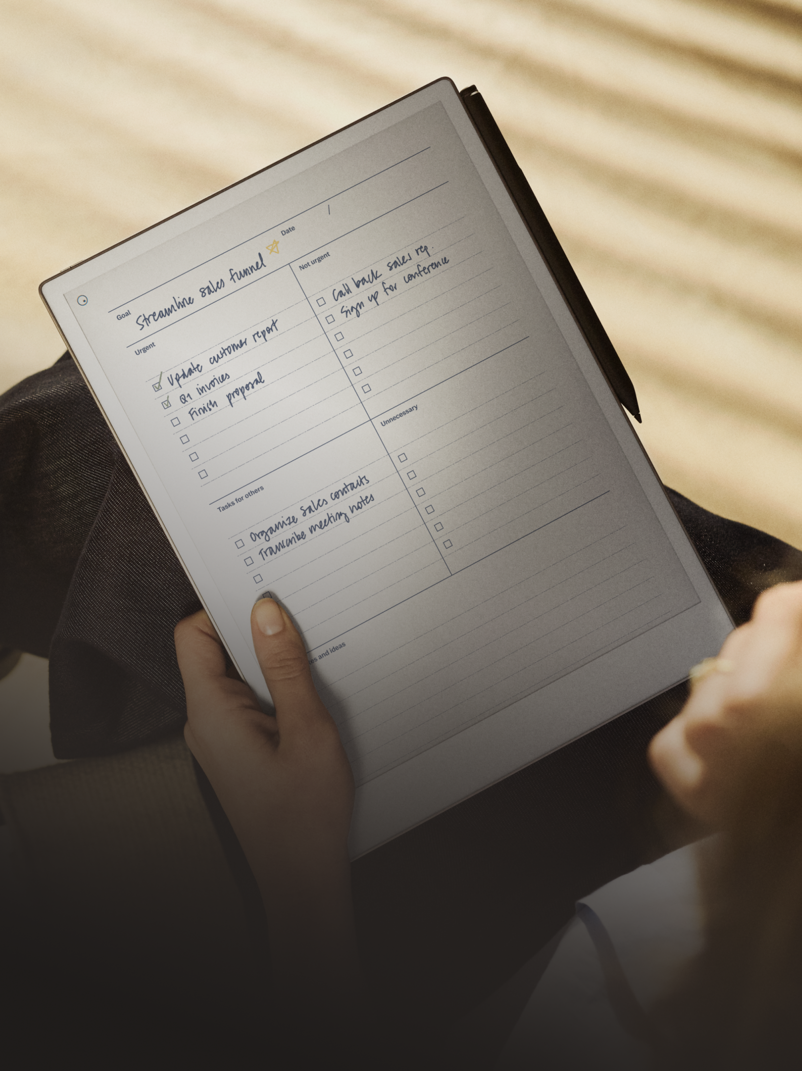 A person with a Remarkable paper tablet on their lap reading notes.