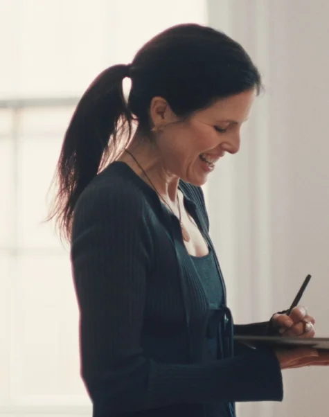 A woman writing with the Marker on a reMarkable paper tablet.