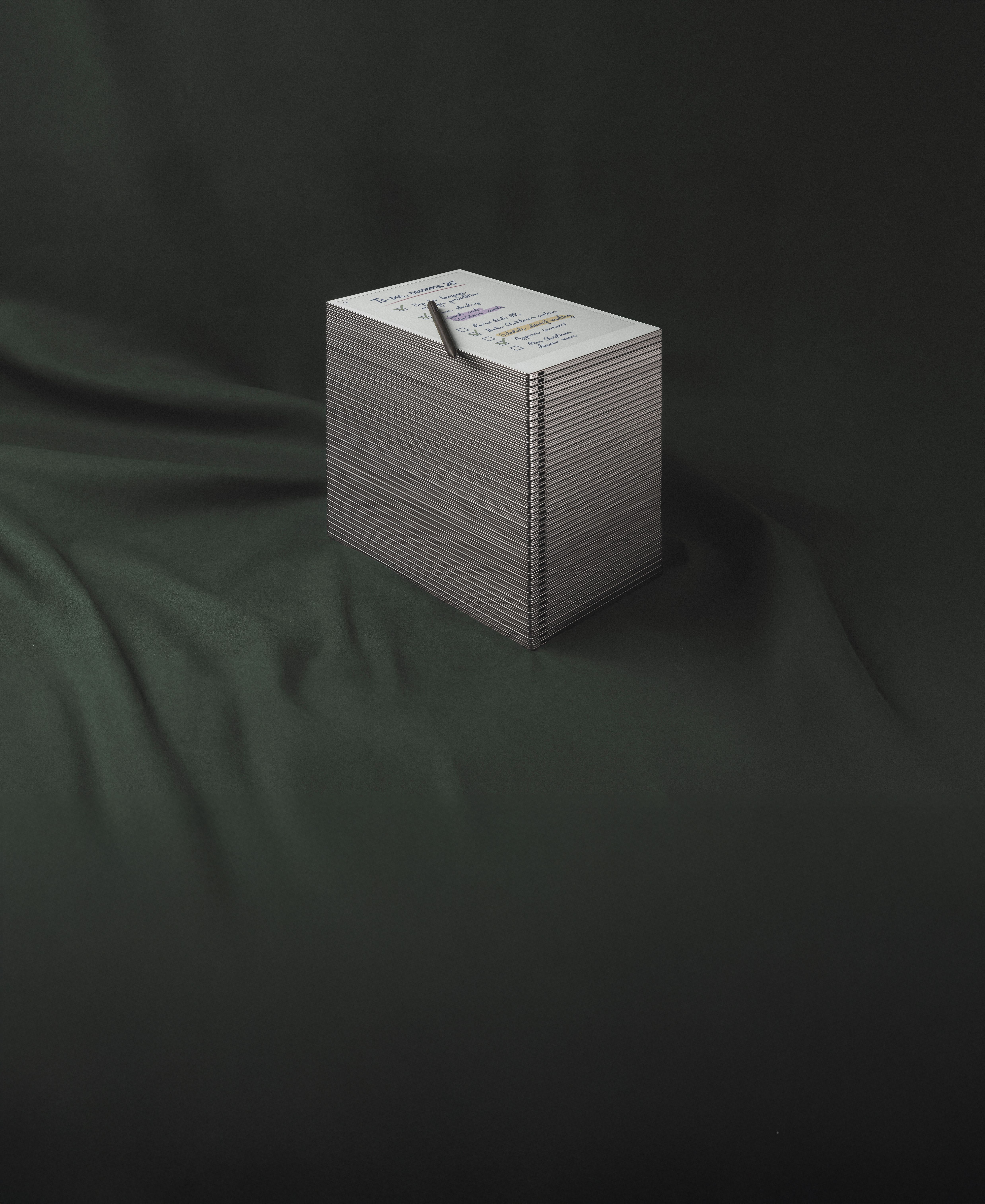 A stack of reMarkable Paper tablets, with a reMarkable Paper Pro with a to-do list on the top.