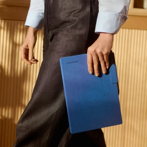 A person carrying a reMarkable Paper Pro with a Book Folio.