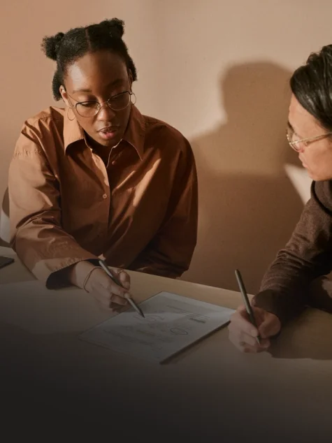Two persons collaborating using a Remarkable paper tablet.
