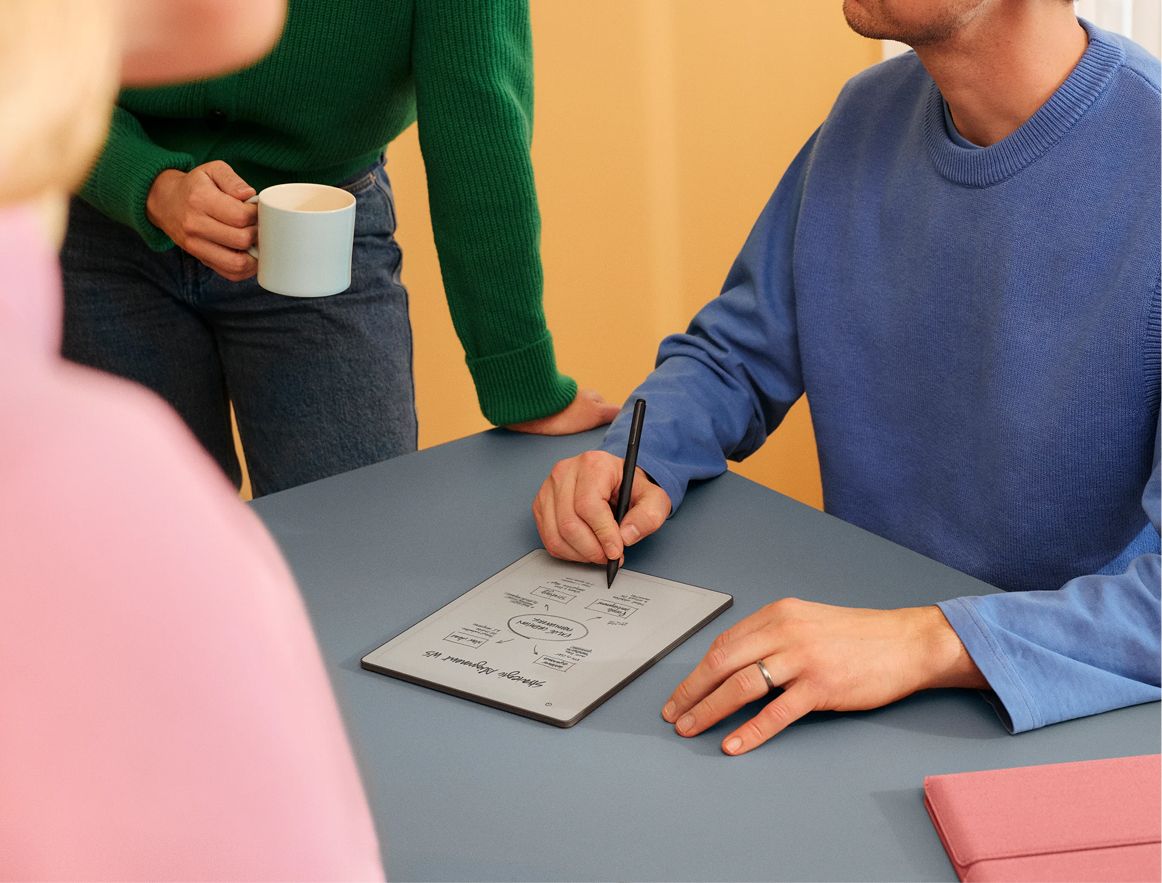 A couple of people having a meeting together while one is taking notes on their reMarkable paper tablet