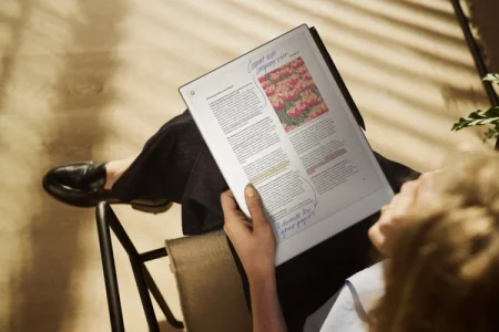 Person reviewing notes on a reMarkable Paper Pro tablet while seated.