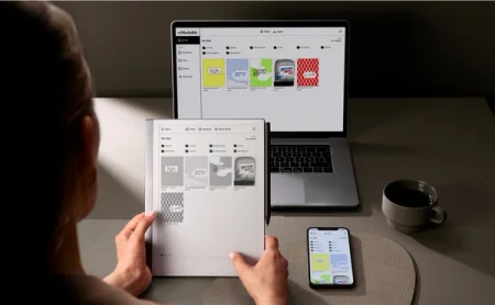 A reMarkable paper tablet next to a laptop and smartphone, displaying file syncing.