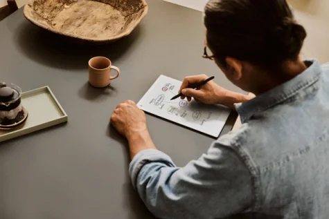 Image of a man taking notes on a reMarkable Paper Pro.