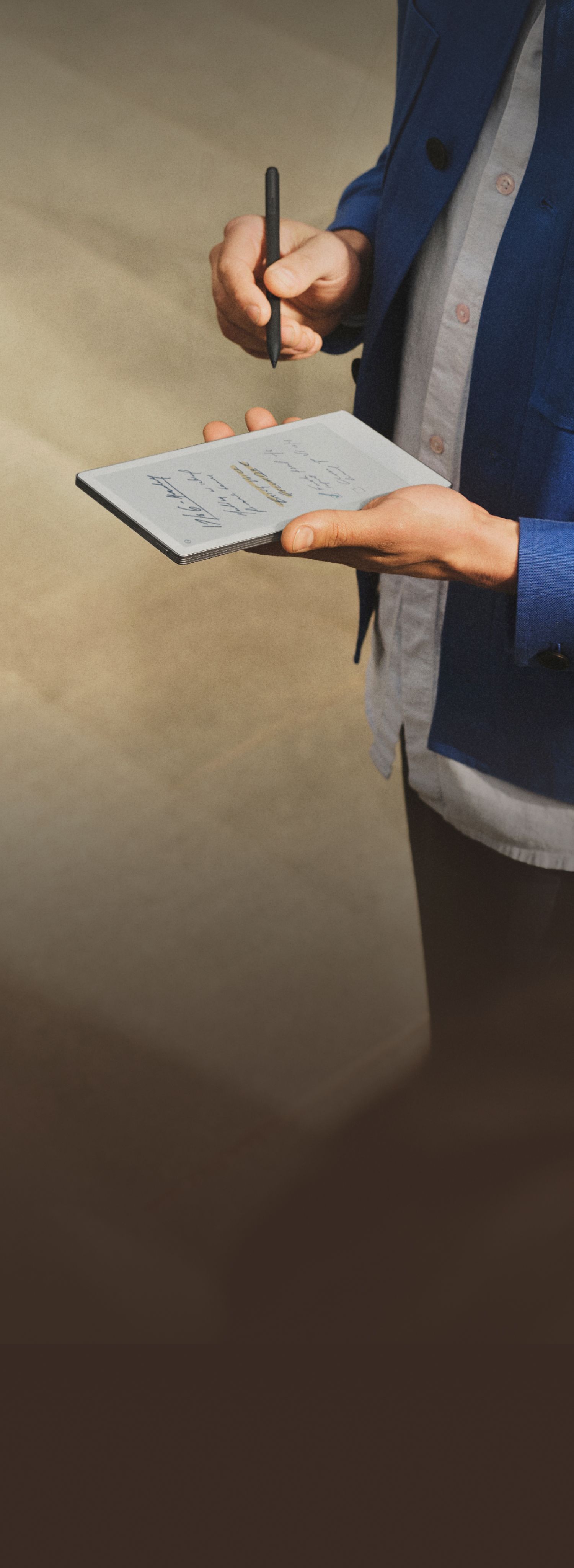 reMarkable Paper Pro Move with handwritten notes; person writing with the Marker.
