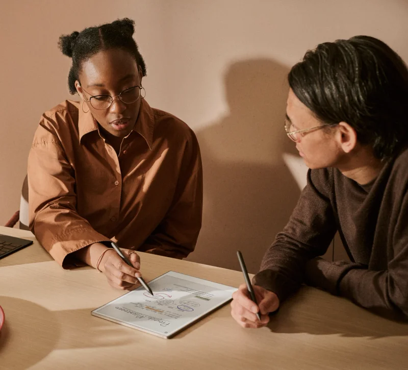 Two people working on device