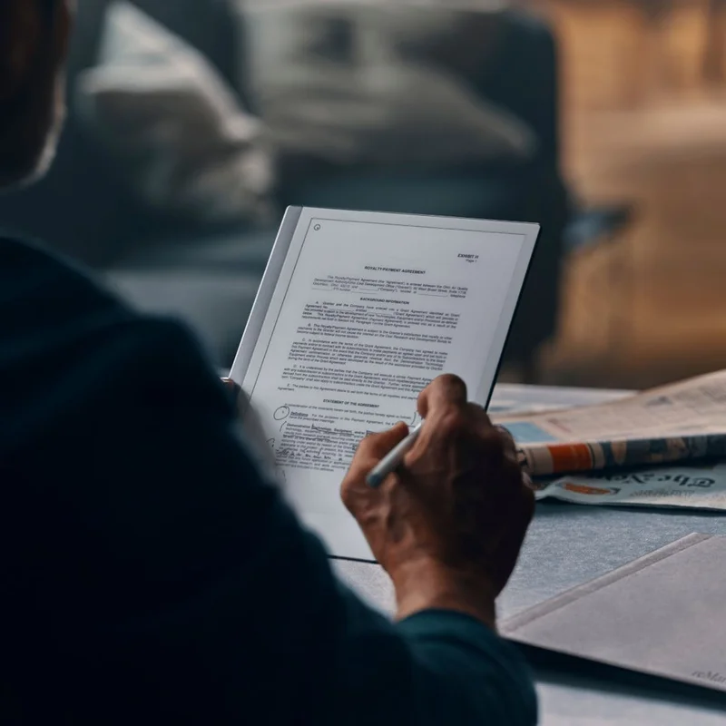 Man reading and writing on reMarkable tablet