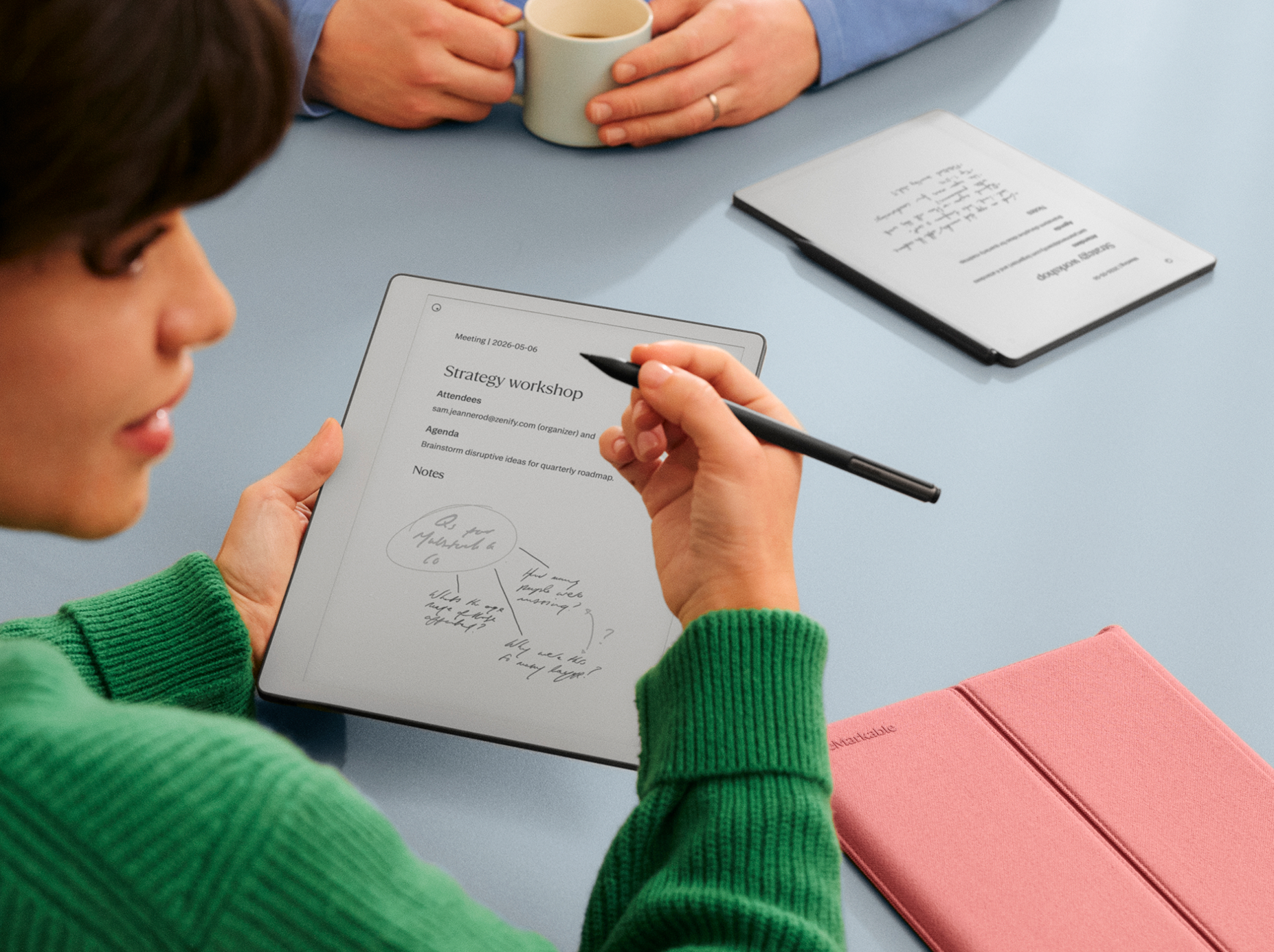 A man and a woman in discussion over notes on a reMarkable Paper Pure