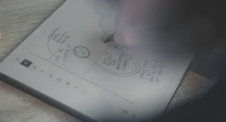 A reMarkable paper tablet showing someone drawing a diagram with the Marker.
