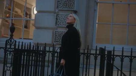 Dorothea Gundtoft walking outside looking up at buildings.