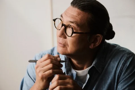 Guy thinking, holding a Marker in his hand