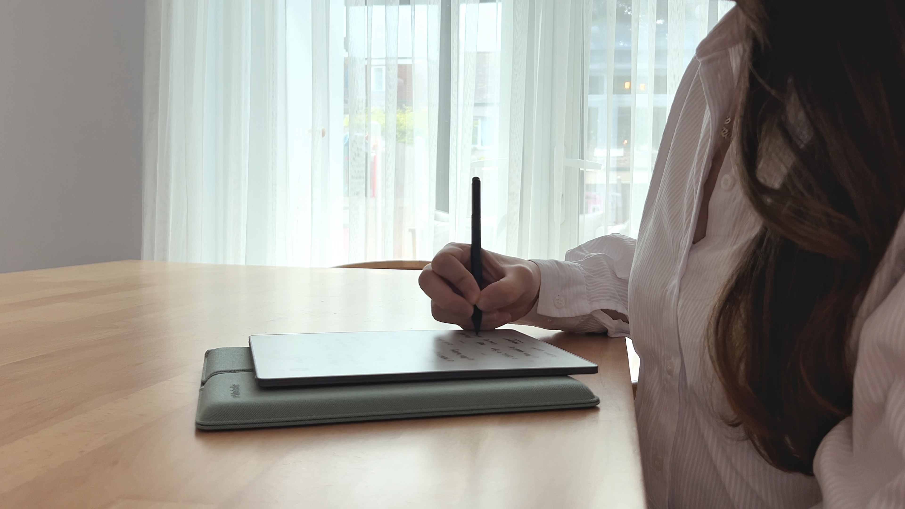 Hazal taking notes on her reMarkable Paper Pure tablet.