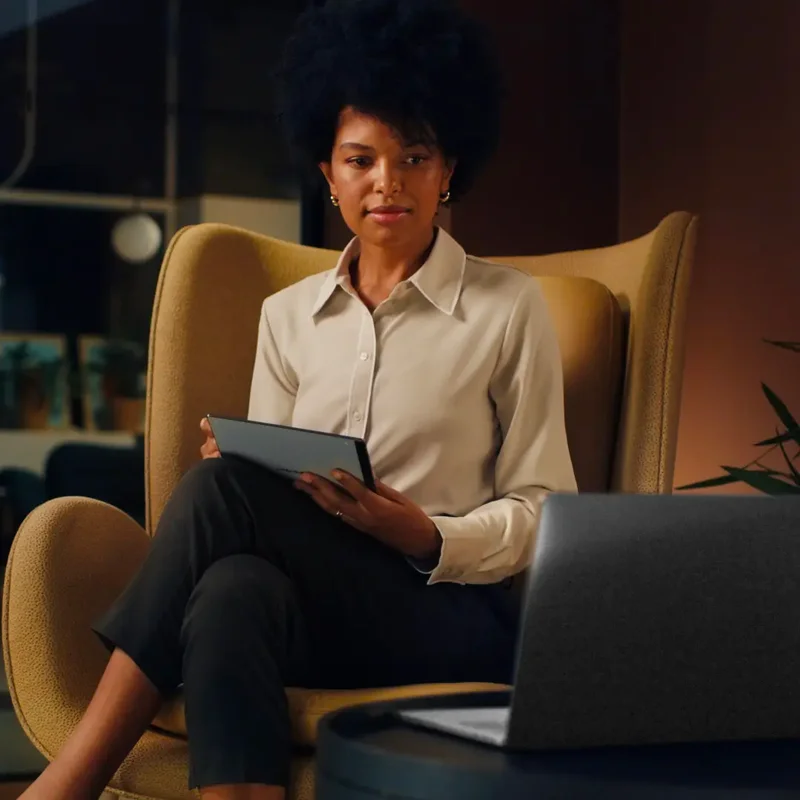 Woman in chair with reMarkable tablet