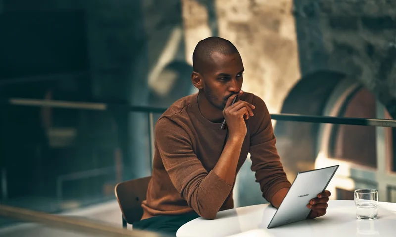 Man sitting at table with a reMarkable paper tablet