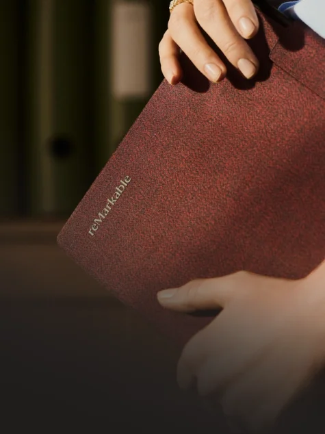 Person holding a reMarkable paper tablet with a Book Folio.