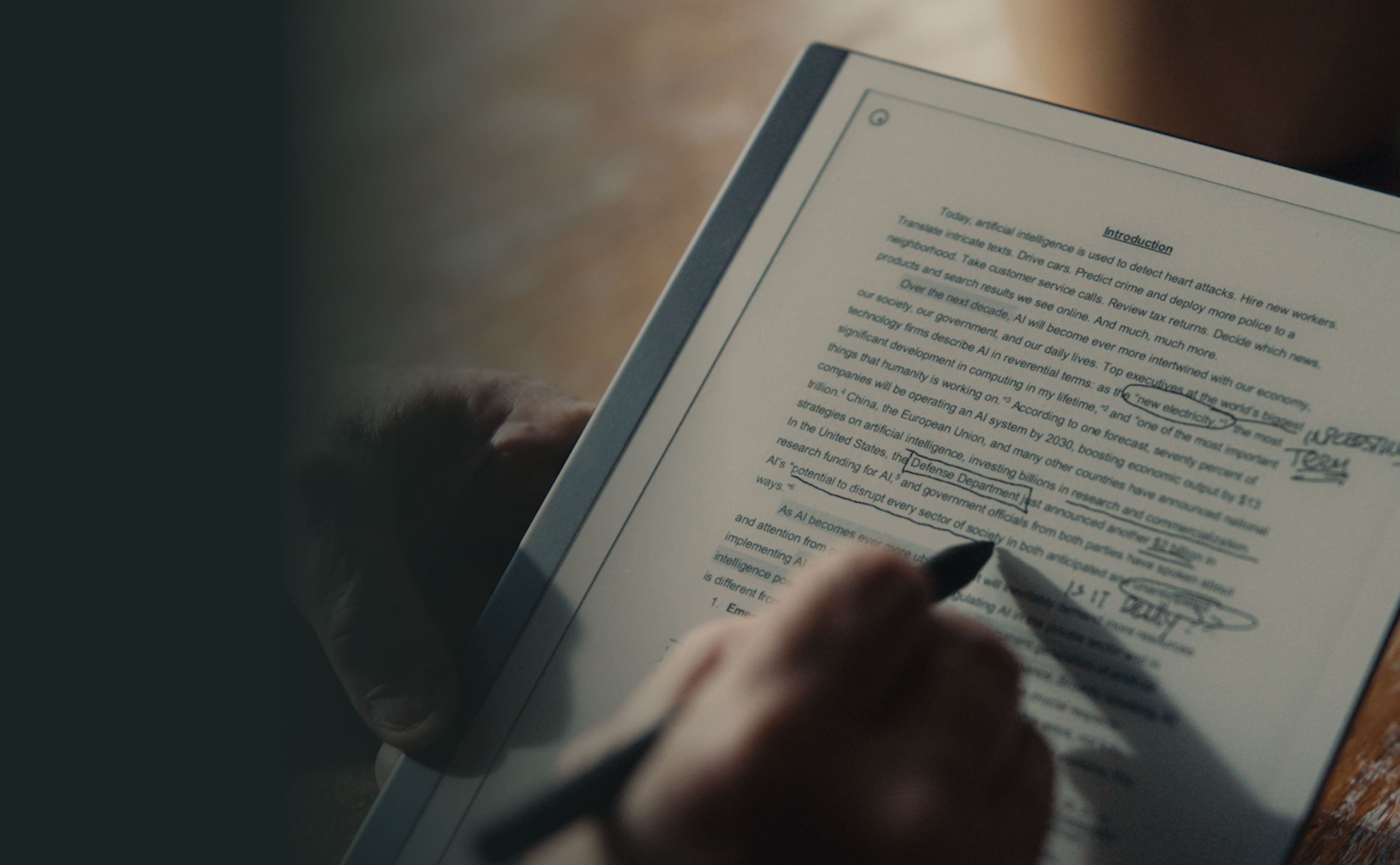 Person writing on reMarkable tablet