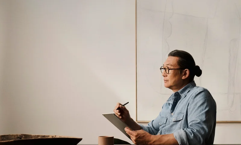 Person writing on a reMarkable Paper Pro with Marker Plus at a table.