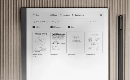 A reMarkable paper tablet displaying project folders and documents next to the Marker.