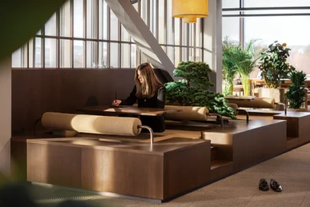 A woman is sitting in the zen garden at reMarkable's new headquarters. She's working on her reMarkable 2.