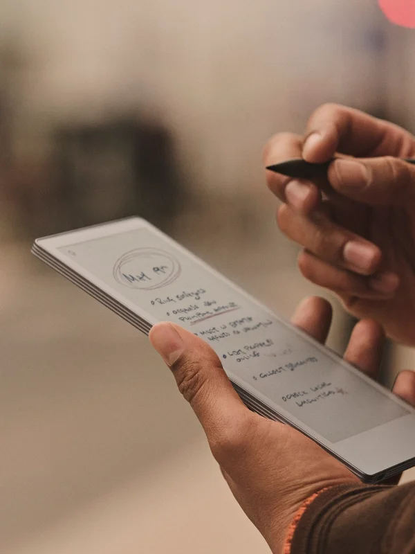 reMarkable Paper Pro Move tablet with handwritten notes and the Marker in use.