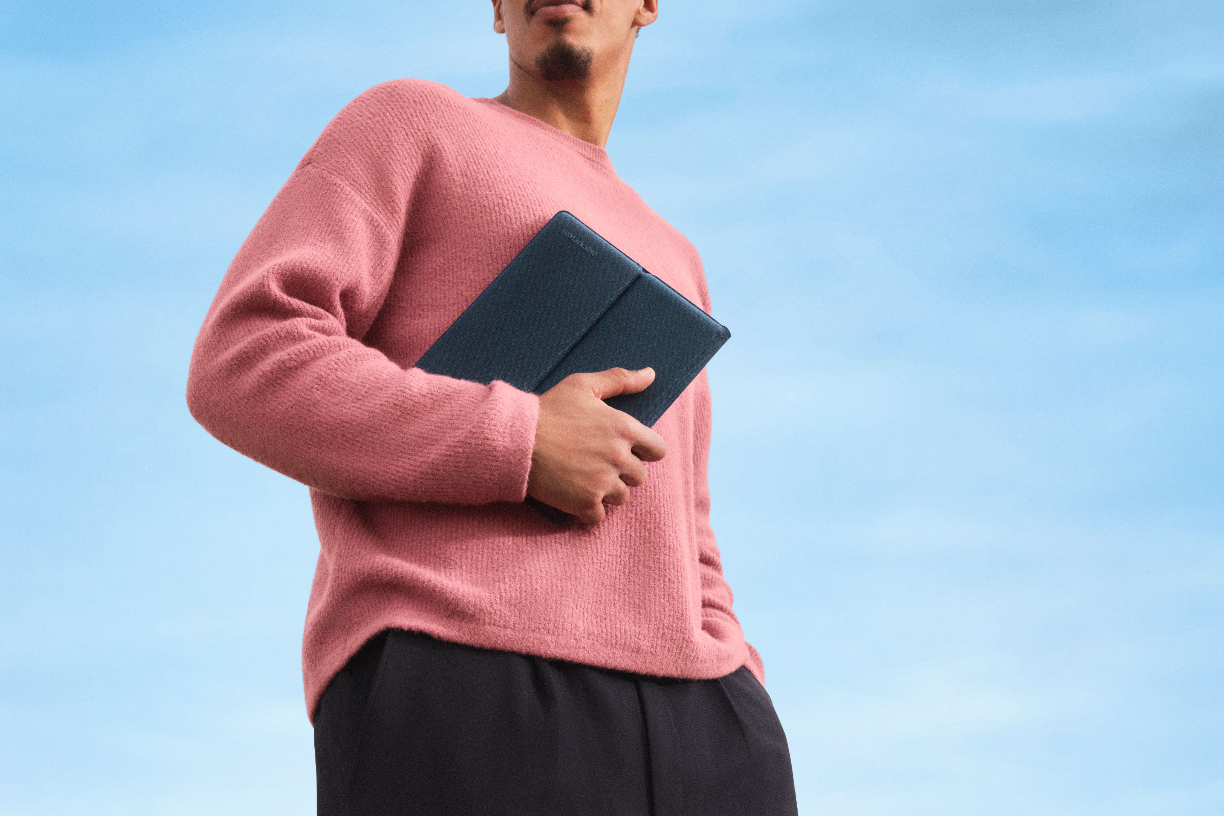 A man holding a reMarkable Paper Pure