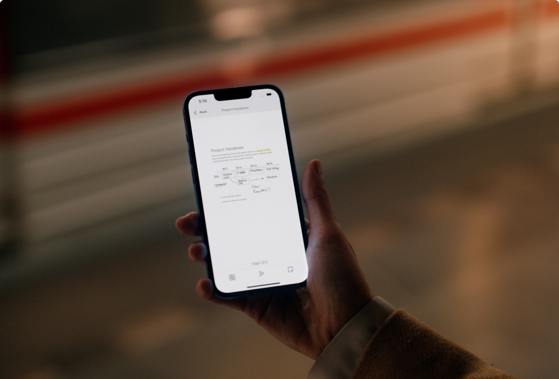 Hand holding a mobile phone, displaying a reMarkable 2 notebook page in the mobile app.