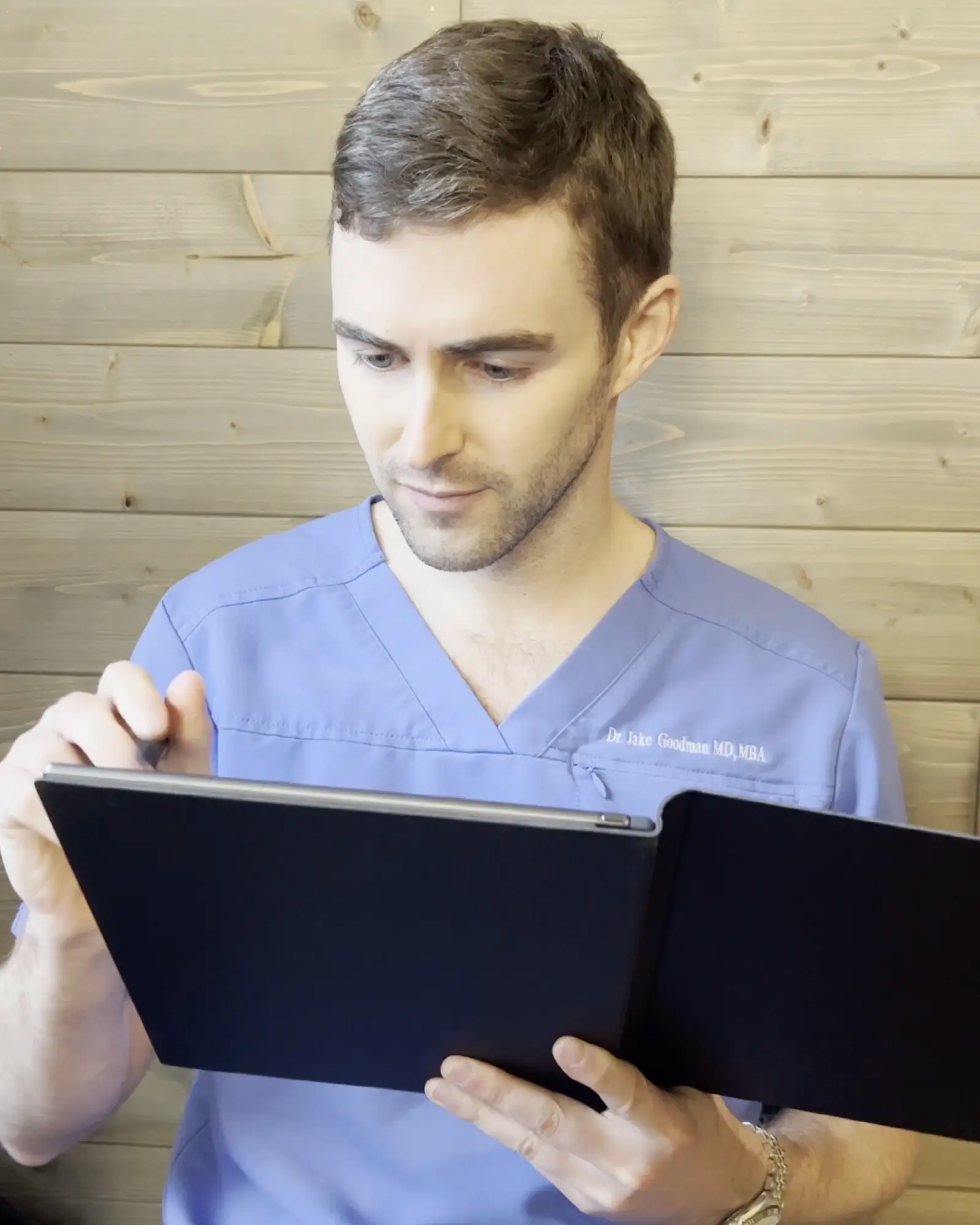 Man using reMarkable paper tablet.