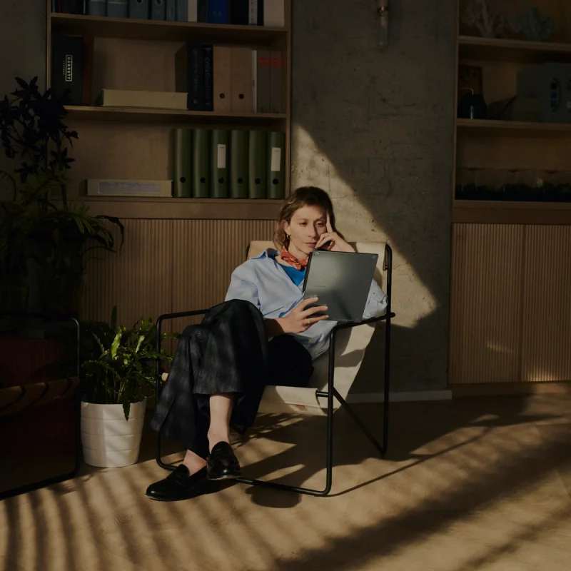 Person sitting on chair with device