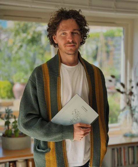 Jake Ogden holding his reMarkable Paper Pure