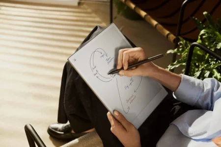 A person drawing a diagram on a reMarkable paper tablet with the Marker.