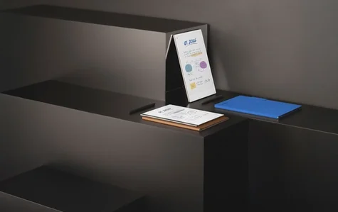 reMarkable Paper Pro and reMarkable 2 paper tablets with folios and Marker Plus’ laid out on an isometric black display structure.