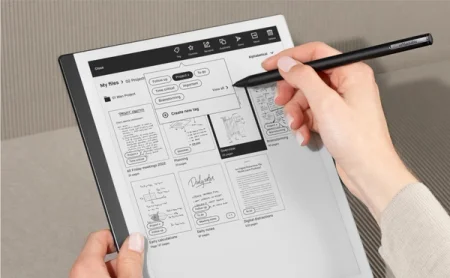 A hand using the Marker on the reMarkable paper tablet.