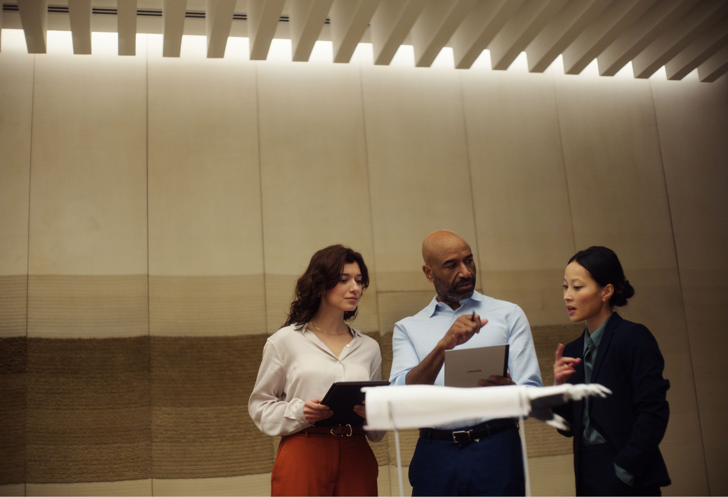 people discussing using reMarkable paper tablet during a business meeting
