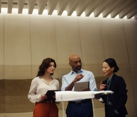 people discussing using reMarkable paper tablet during a business meeting