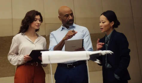 people discussing using reMarkable paper tablet during a business meeting