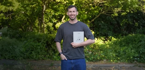 Gabriel Nussbaum standing outside holding his reMarkable Paper Pure.