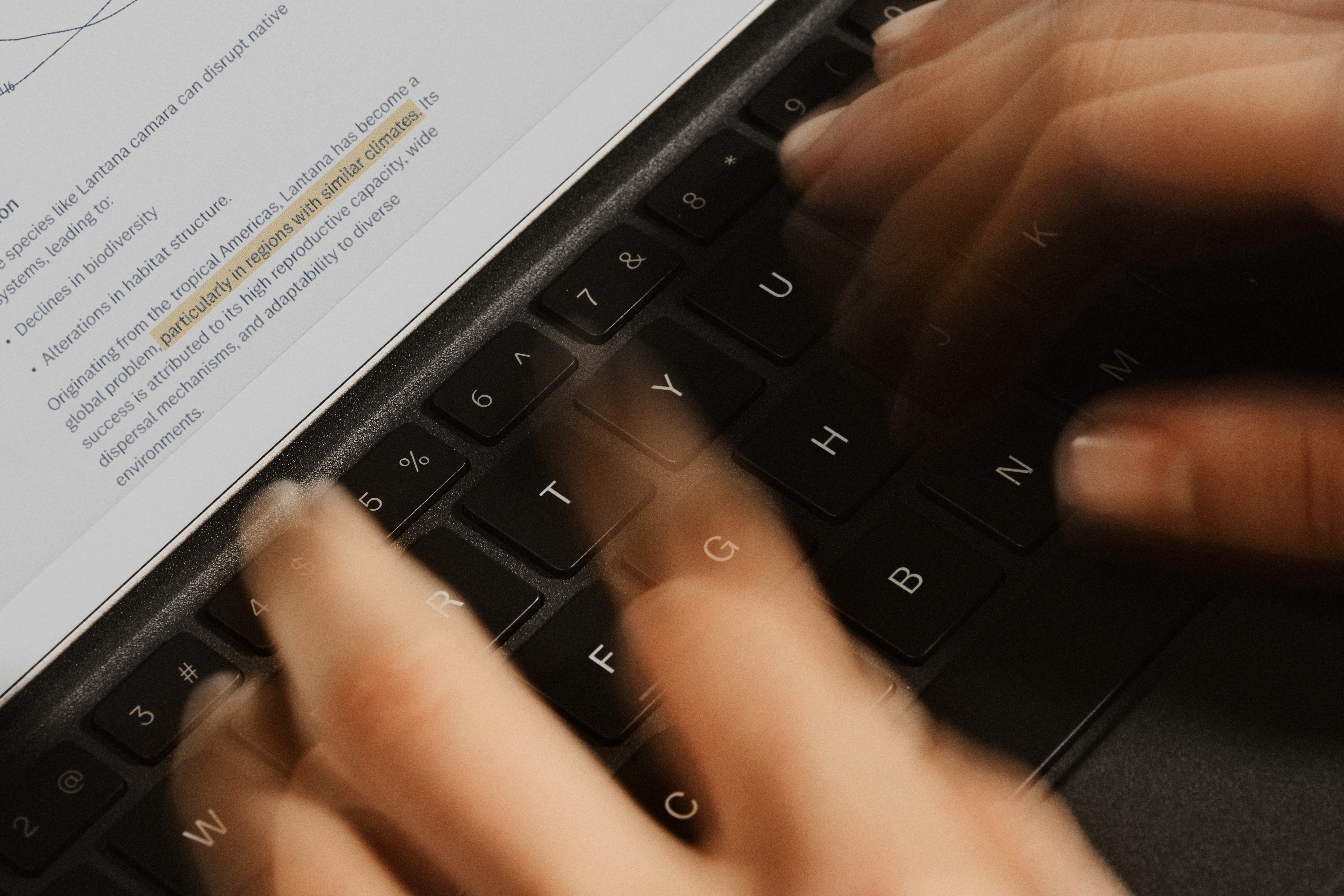 Close-up of hands typing fast on a Type Folio on a reMarkable Paper Pro tablet.