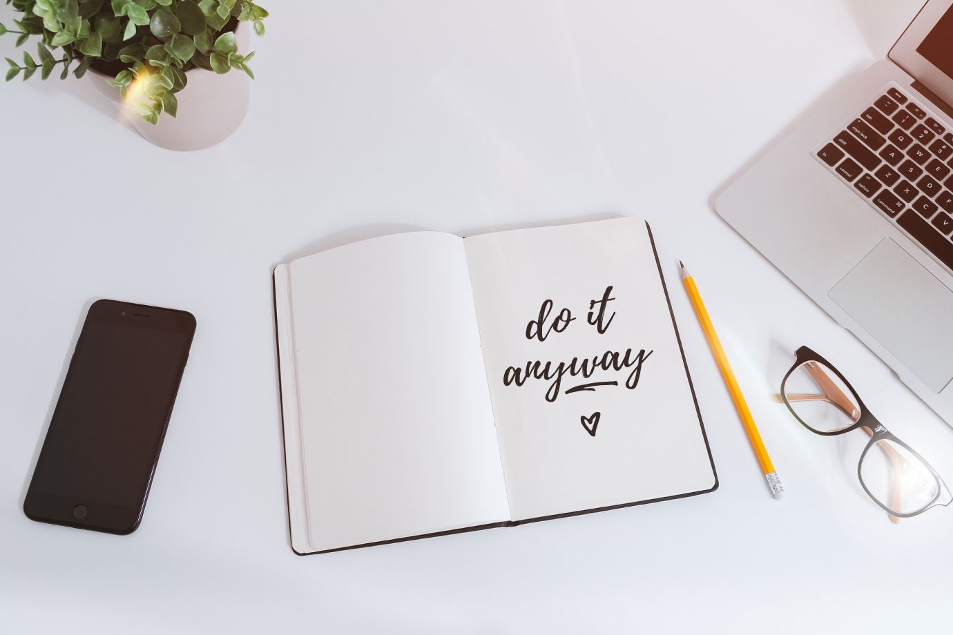 Notebook with a note that says, "Do it anyway"