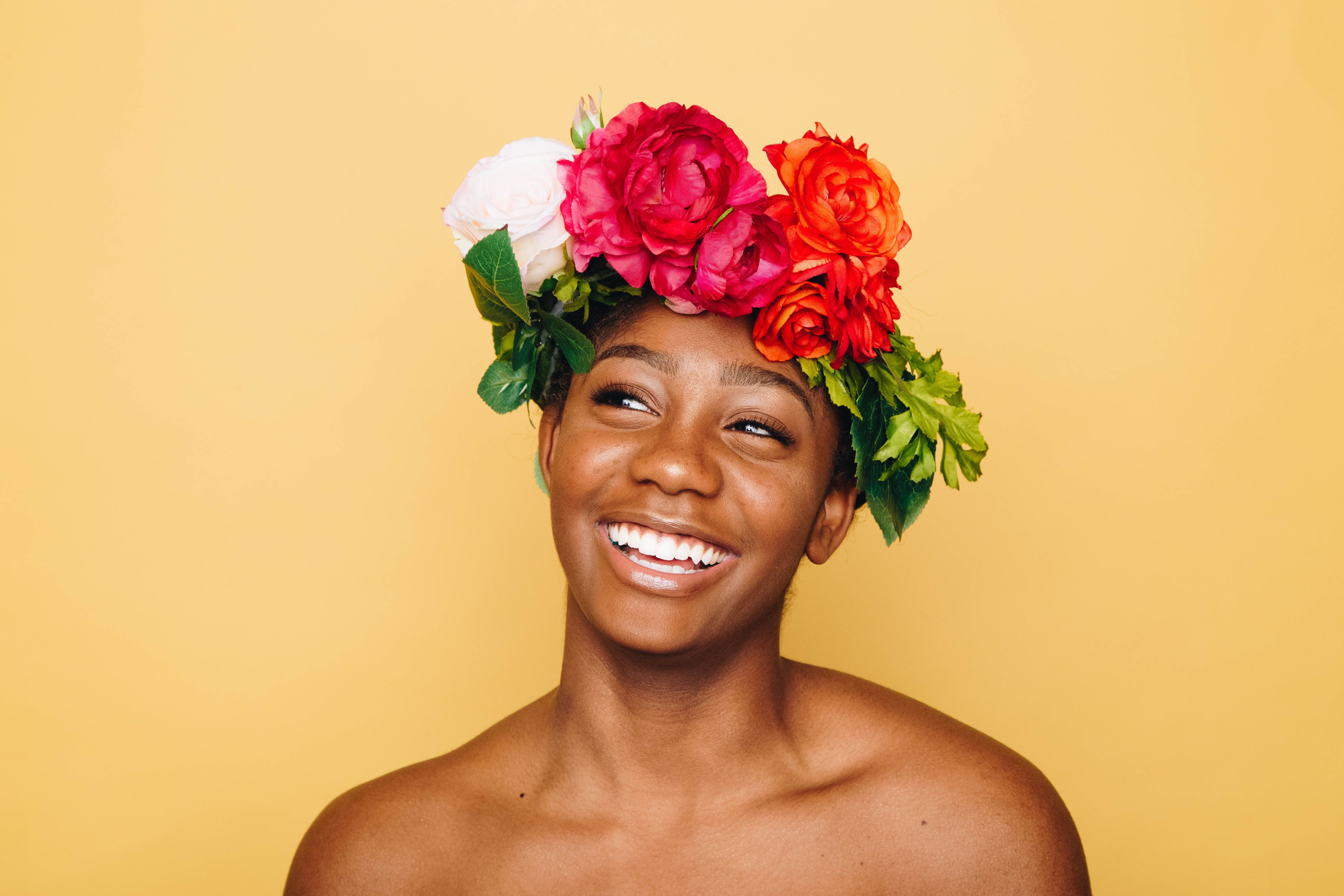 Woman wearing a crown of flowers and smiling