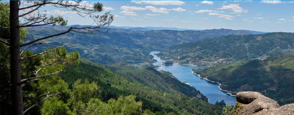 A view of Peneda-Gerês National Park with a view of a river through rolling hills.