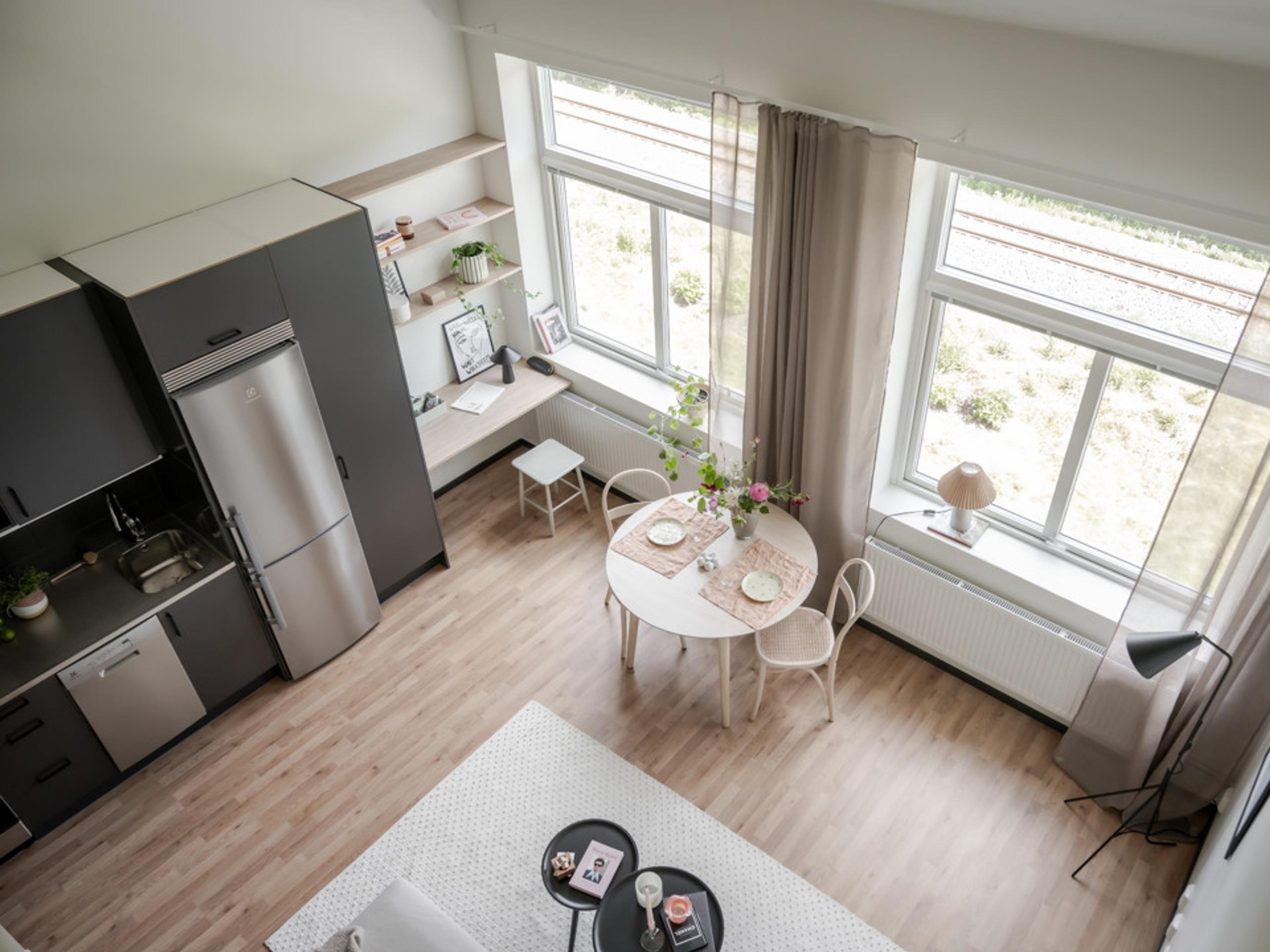 view over a living room, a dining room and a kitchen from above.