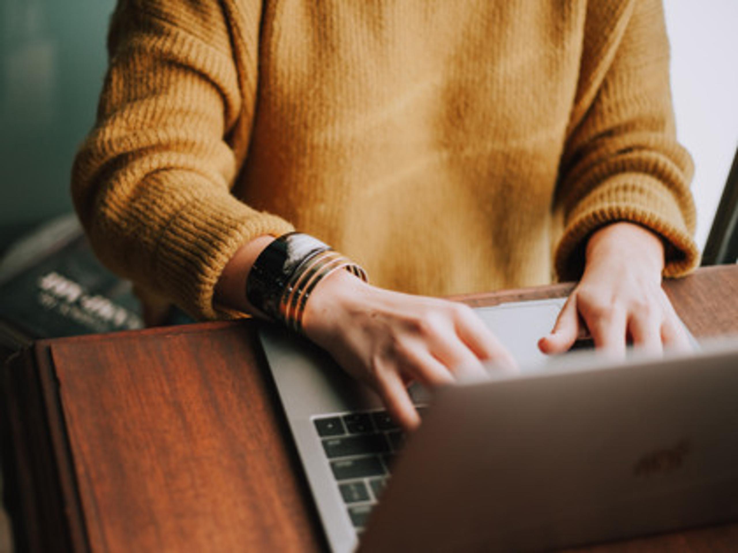 woman typing on a laptop