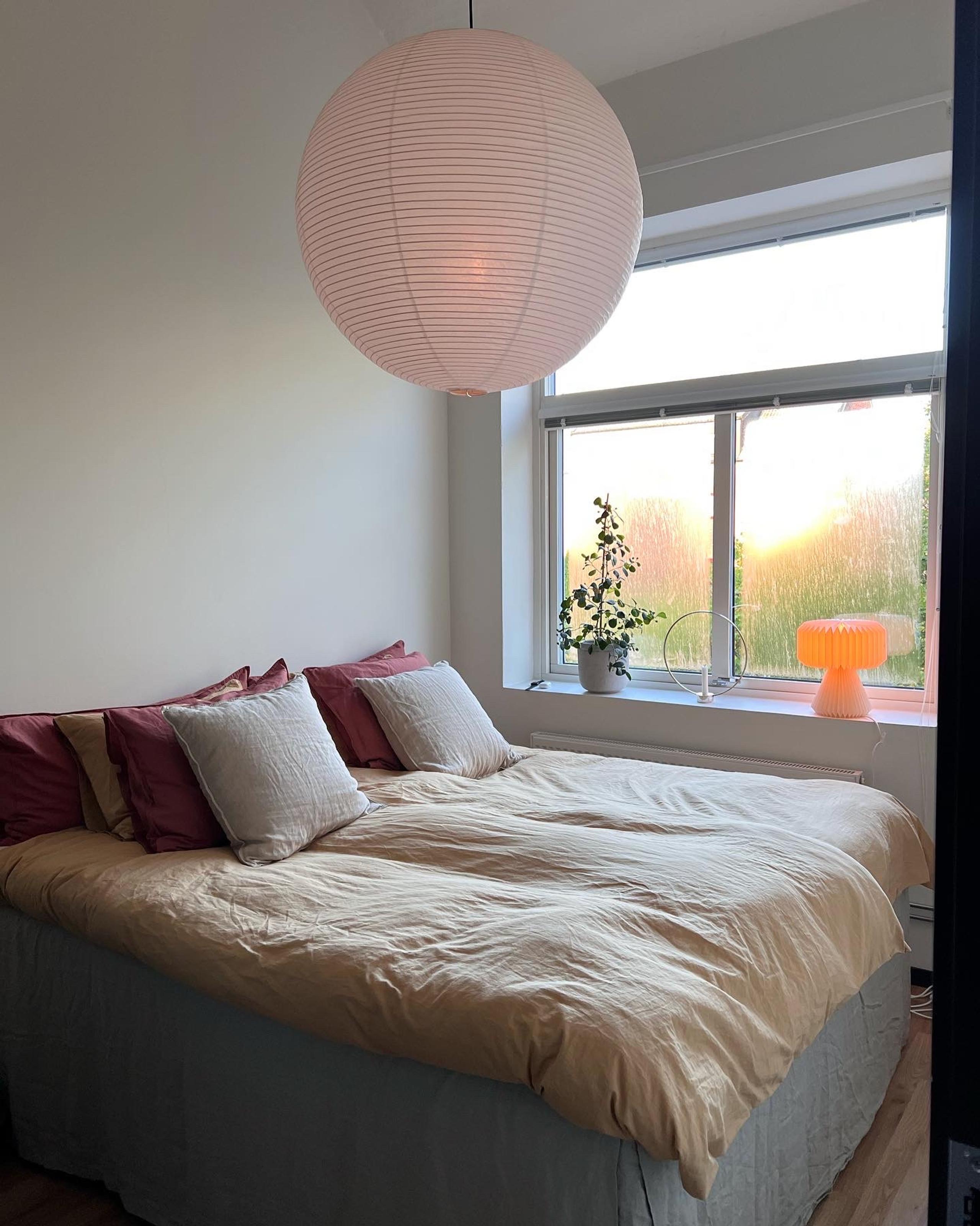 bedroom with a large bed and a large window.