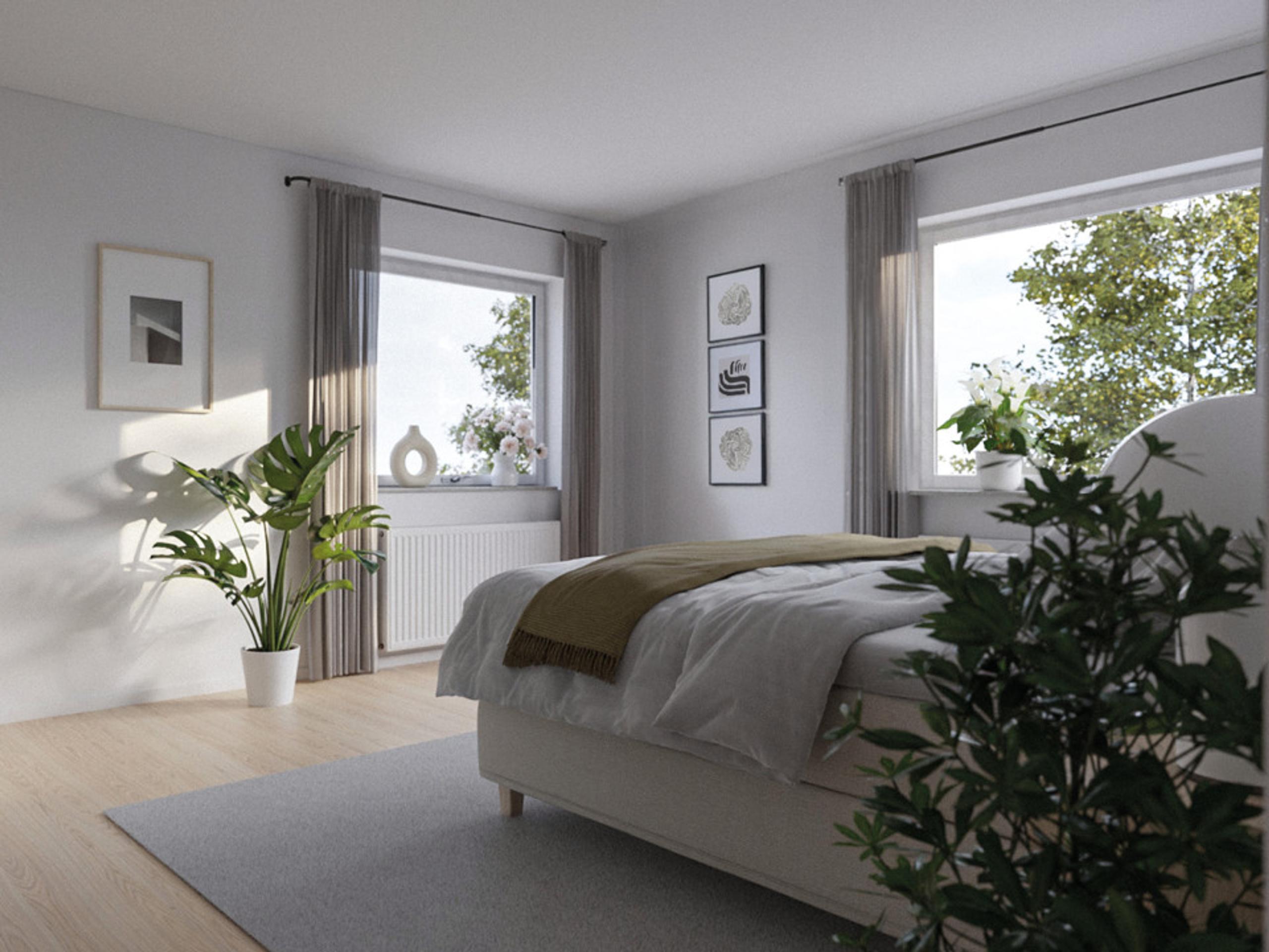 bedroom with a bed and a potted plant.