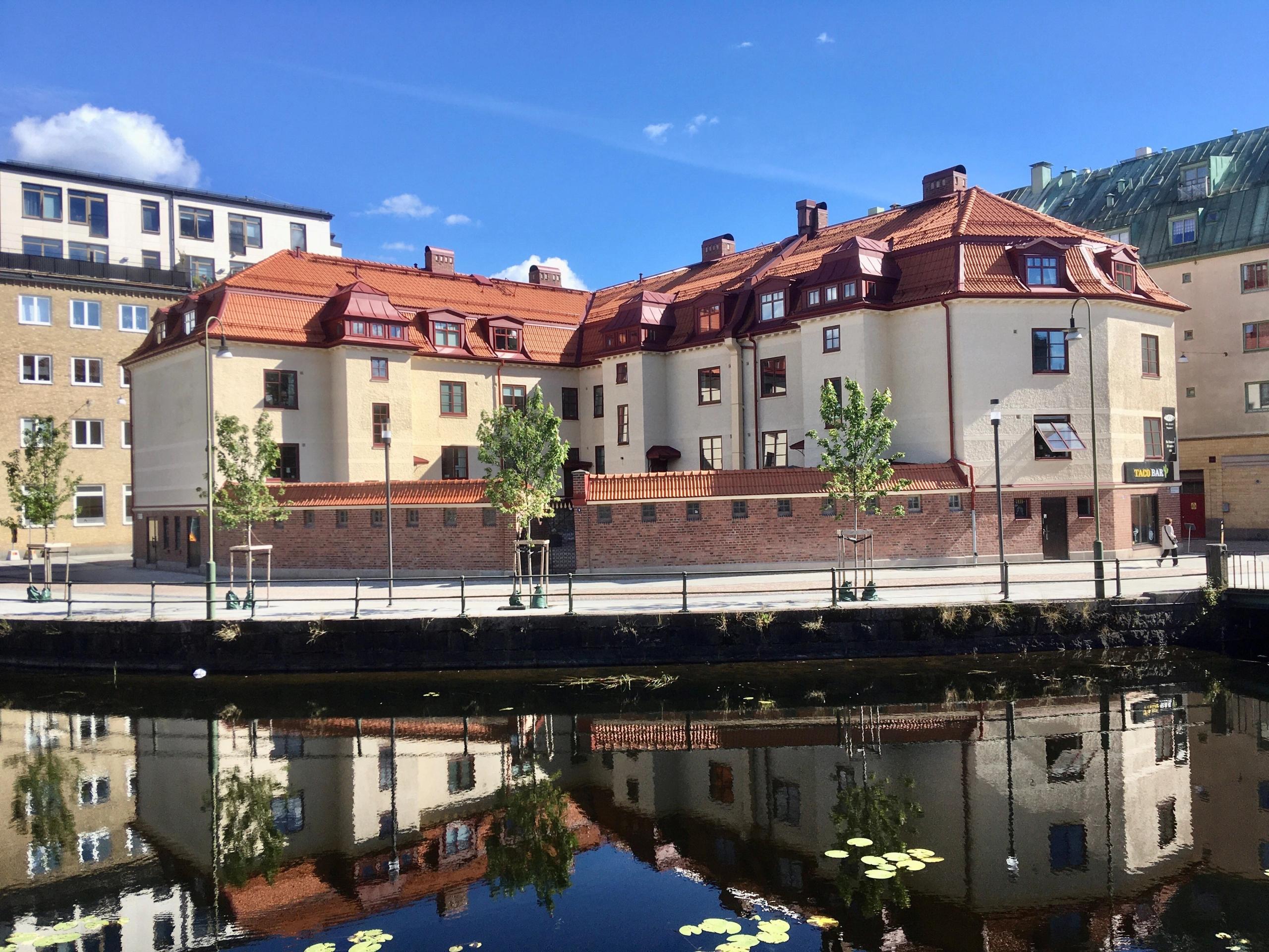 building in an urban setting with a river in front