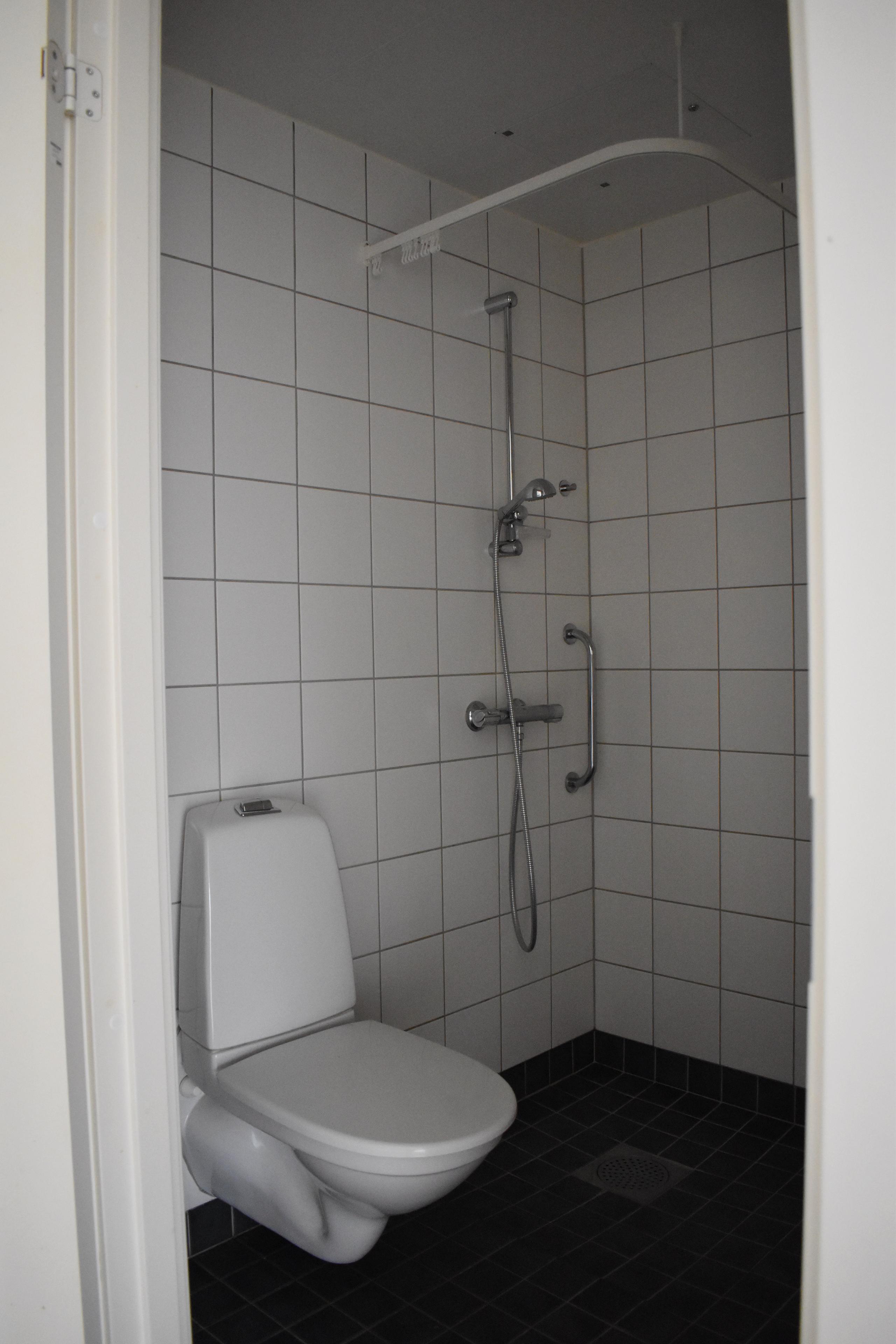 Student apartment. Fully tiled bathroom with shower and toilet.