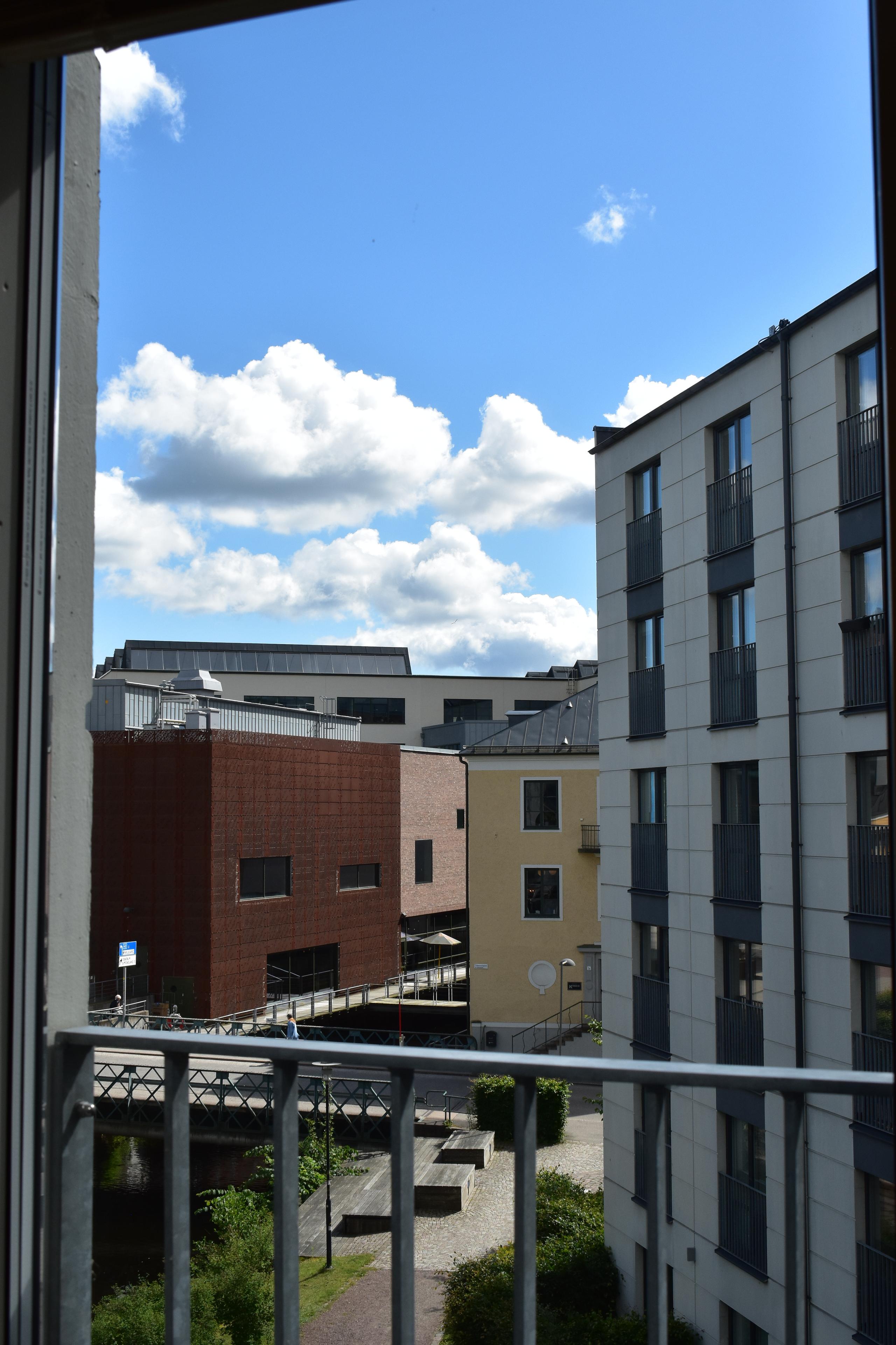 Student apartment. View from a Juliet balcony over the Viskan river and buildings.